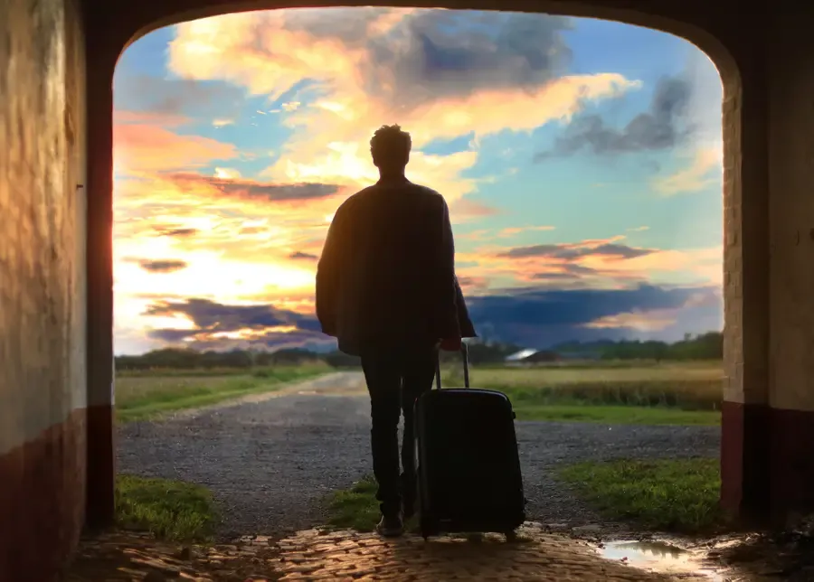 Traveler walking into a new sunrise